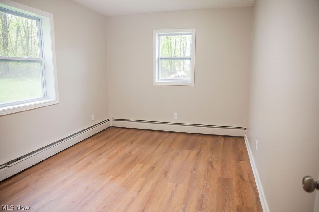 3644 Padanarum Road Geneva, OH 44041 - Photo 11 of 19 Room featuring warm neutral wall tones and wood-finish flooring