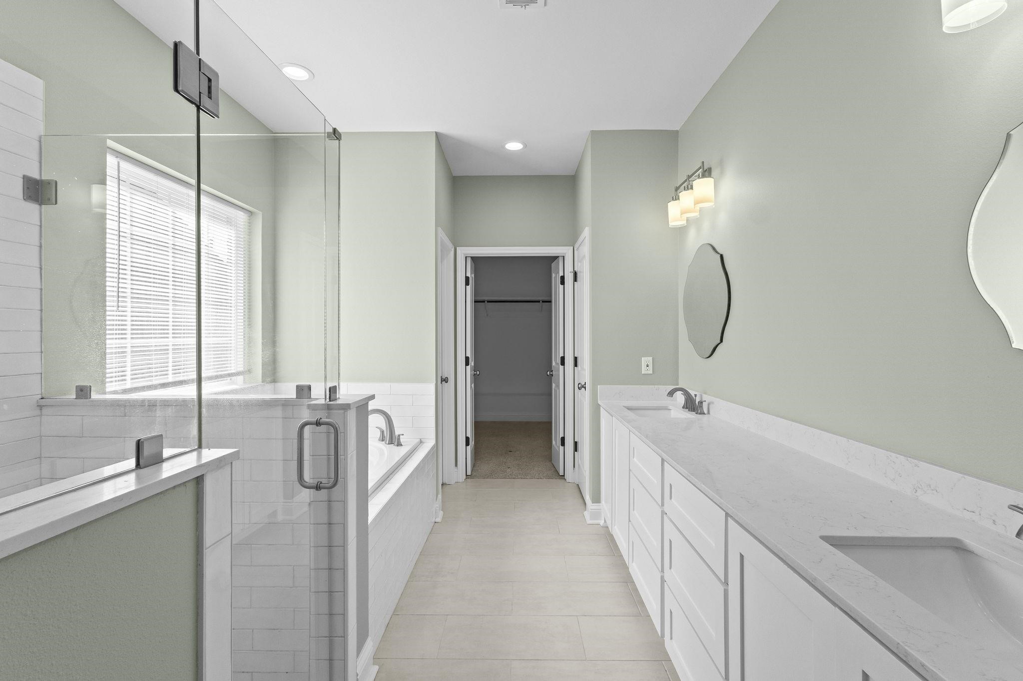 790 Bridgeview Street Bridge City, TX 77611 - Photo 16 of 31 a spacious bathroom with a double vanity sink a mirror a window and a bathtub