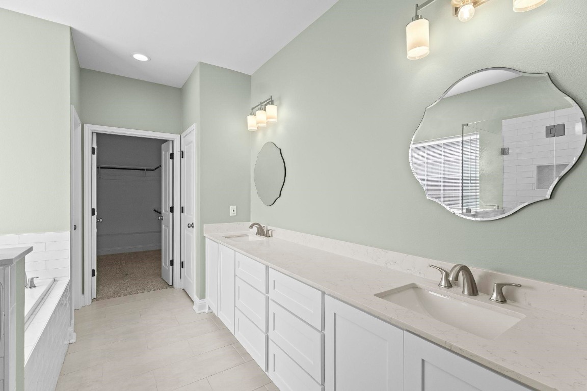 790 Bridgeview Street Bridge City, TX 77611 - Photo 17 of 31 a spacious bathroom with a double vanity sink double mirror and a mirror