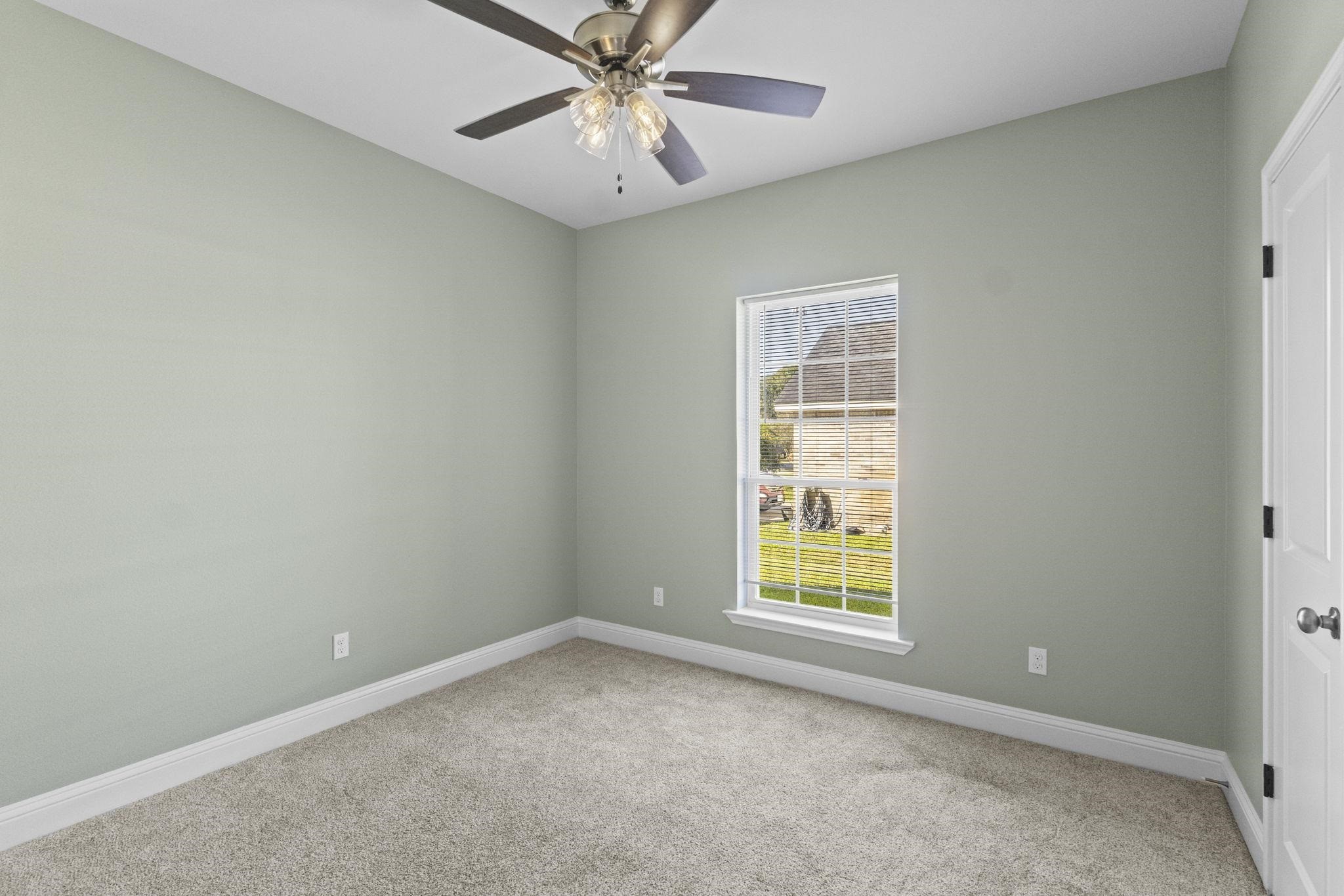 790 Bridgeview Street Bridge City, TX 77611 - Photo 22 of 31 an empty room with a window and a fan