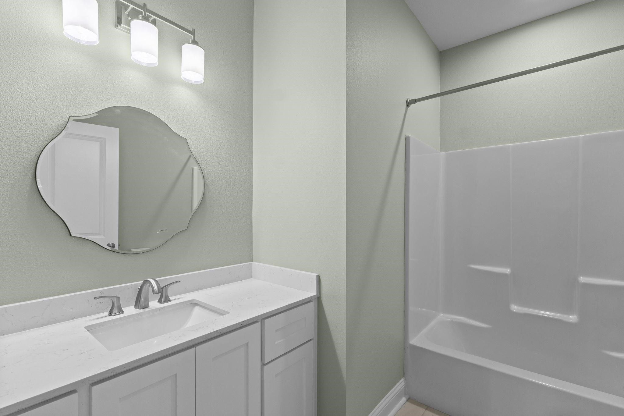 790 Bridgeview Street Bridge City, TX 77611 - Photo 23 of 31 a bathroom with a sink and a mirror