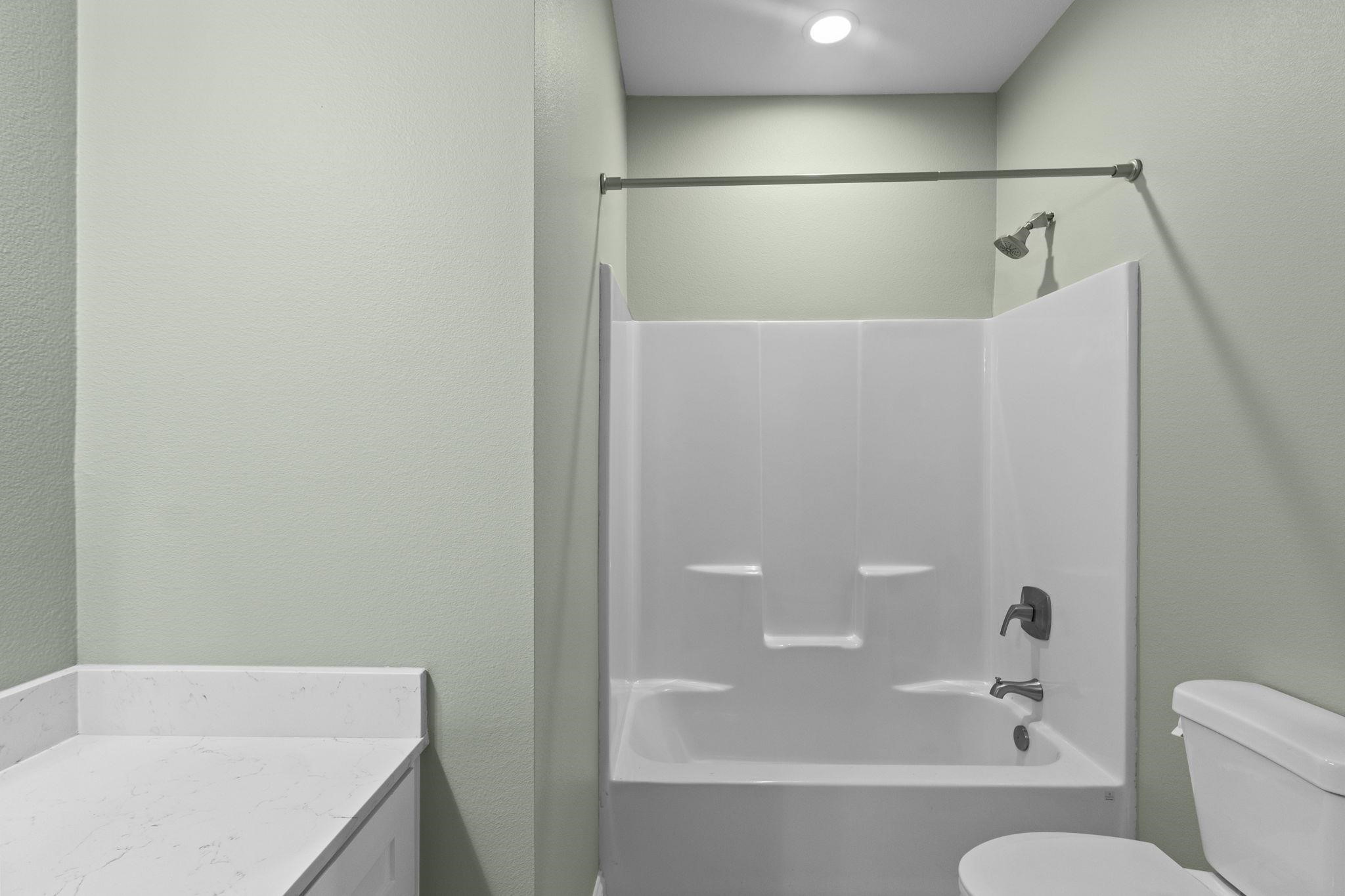 790 Bridgeview Street Bridge City, TX 77611 - Photo 24 of 31 a bathroom with a bathtub and toilet