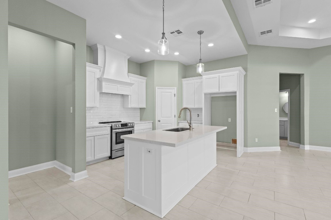 790 Bridgeview Street Bridge City, TX 77611 - Photo 7 of 31 a large white kitchen with a large window