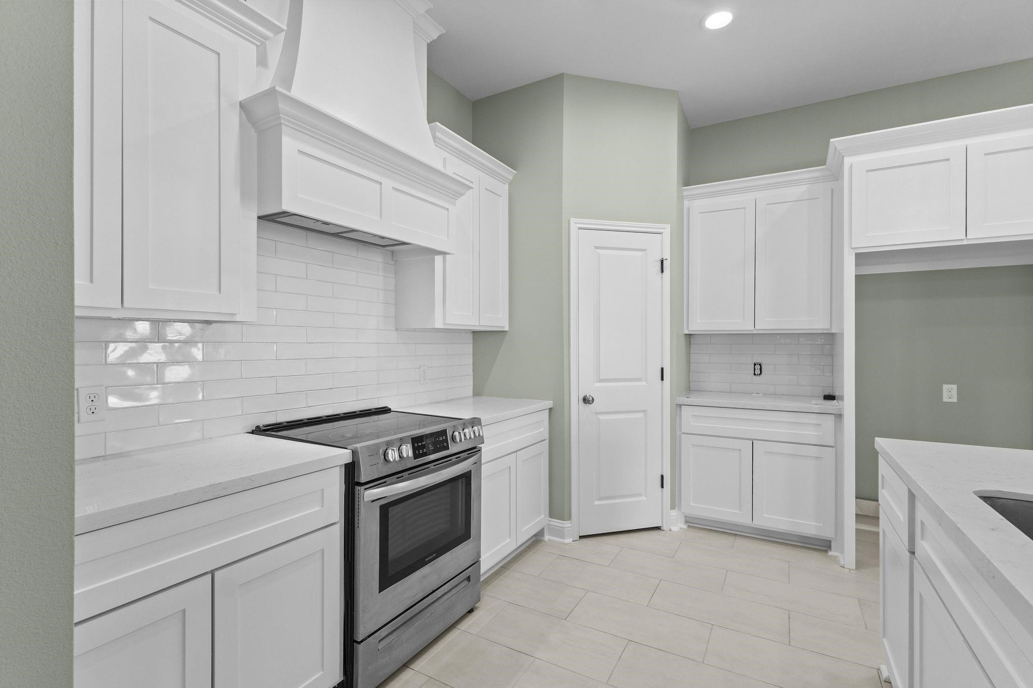 790 Bridgeview Street Bridge City, TX 77611 - Photo 8 of 31 a kitchen with white cabinets and white appliances