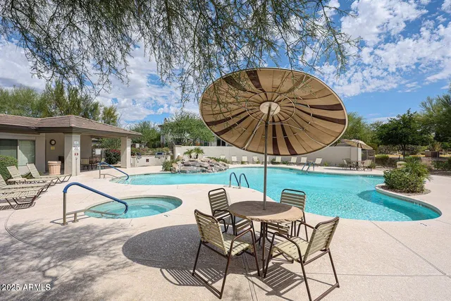 a swimming pool with outdoor seating yard and barbeque oven