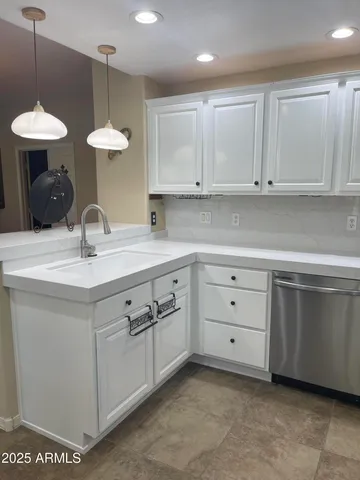 a kitchen with cabinets appliances and a sink