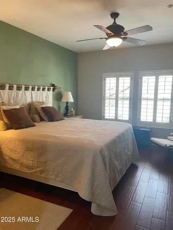 a large bed sitting in a bedroom next to a window