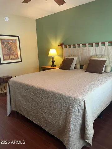 a bedroom with a bed and lamp