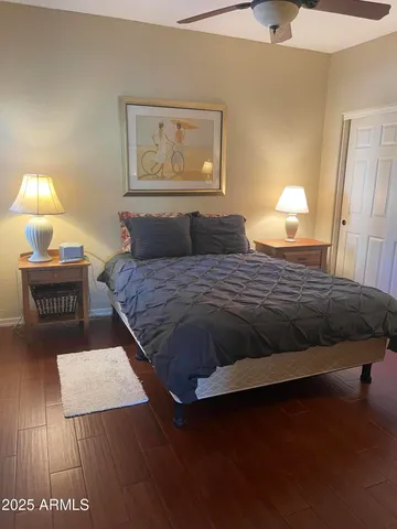 a bedroom with a bed and a night stand