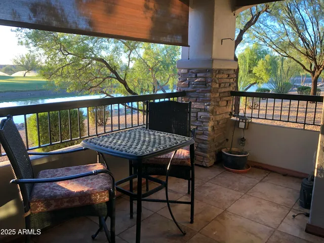 a view of a chairs and table in the balcony