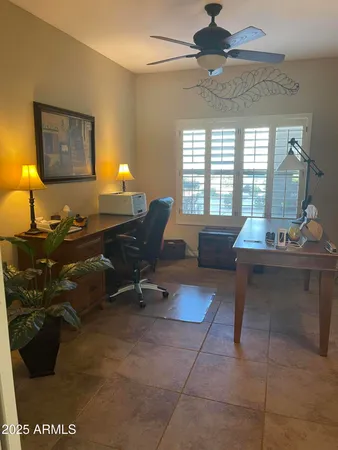 a living room with furniture a window and a potted plant