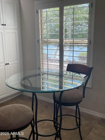 a workspace room with furniture and window