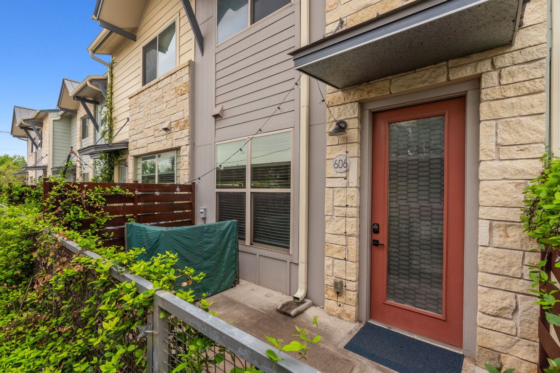 7805 Cooper Lane, Unit 606 Austin, TX 78745 - Photo 1 of 1 a front view of a house with a garden