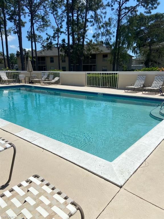 776 Landover Circle, Unit 102 Naples, FL 34104 - Photo 21 of 24 a view of swimming pool with a yard