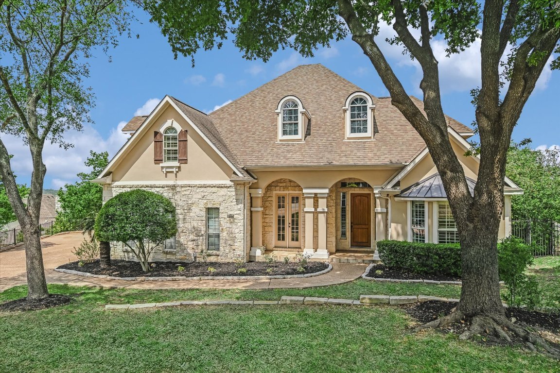 a front view of a house with a yard