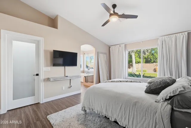 a bedroom with a bed and a flat screen tv