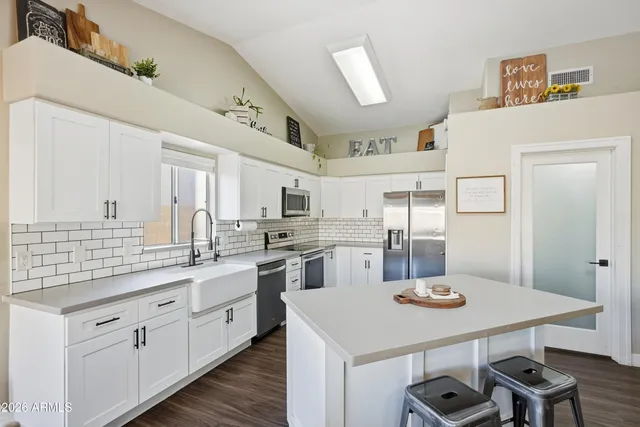 a living room with furniture ceiling fan and a rug