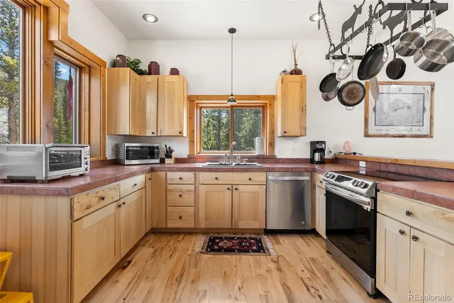 a kitchen with stainless steel appliances a refrigerator and a sink