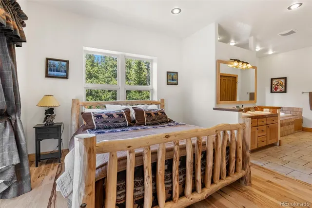 a bathroom with a tub a sink a mirror and a bathtub