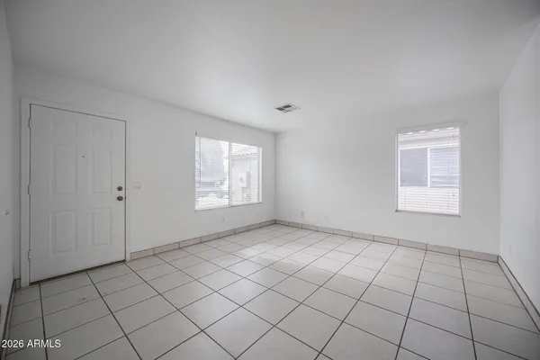 a view of a big room with wooden floor closet and windows