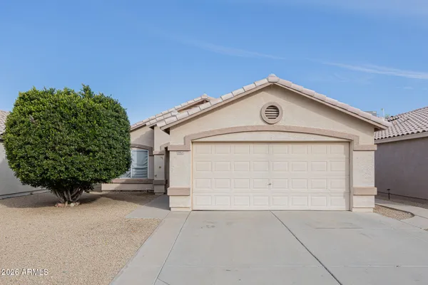 a view of a house with a yard and garage