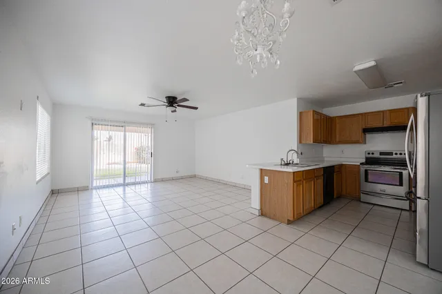 a large kitchen with a stove a sink dishwasher and a refrigerator