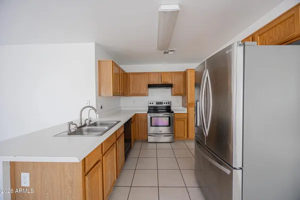 a kitchen with stainless steel appliances a refrigerator sink and stove