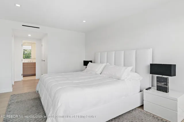 a large white bed in a white room