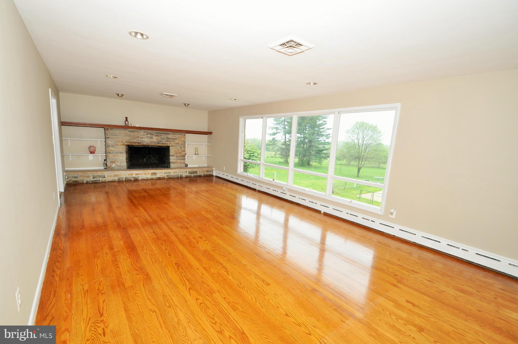 13718 Baldwin Mill Road Baldwin, MD 21013 - Photo 13 of 29 a view of an empty room with a fireplace and a window