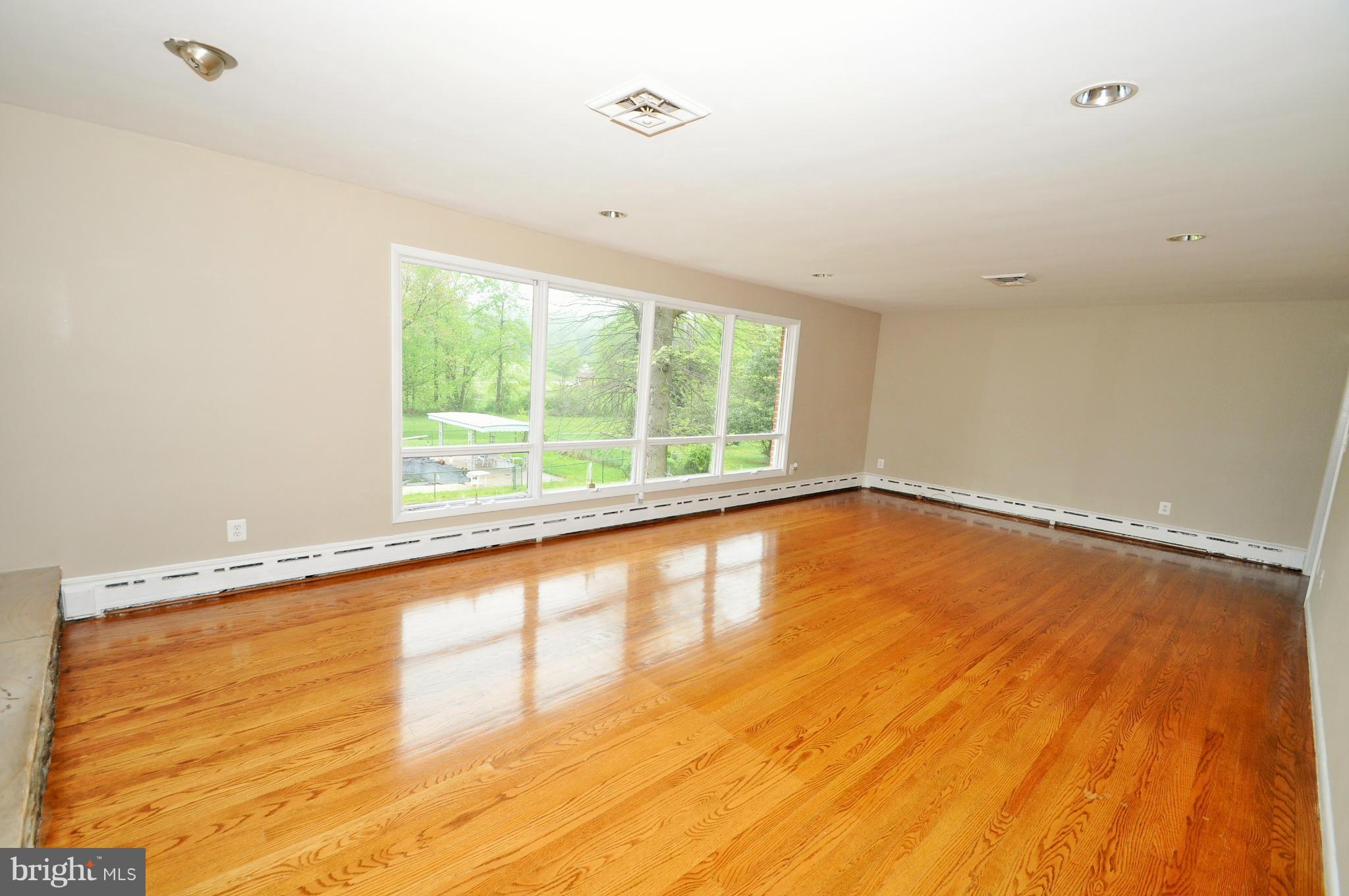 13718 Baldwin Mill Road Baldwin, MD 21013 - Photo 15 of 29 a view of empty room with wooden floor and fan