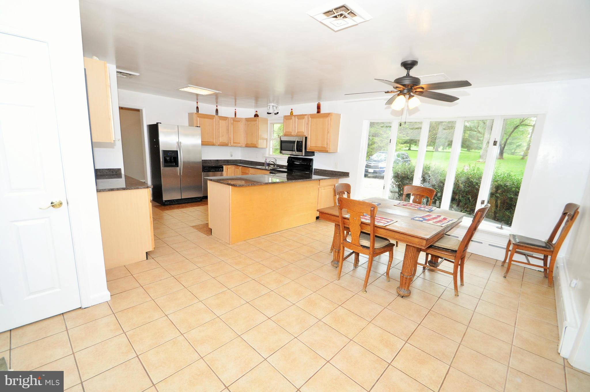 13718 Baldwin Mill Road Baldwin, MD 21013 - Photo 6 of 29 a dining room with furniture and a kitchen view
