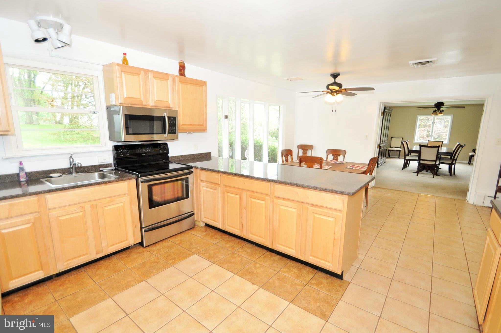 13718 Baldwin Mill Road Baldwin, MD 21013 - Photo 7 of 29 a kitchen with stainless steel appliances a stove sink and microwave