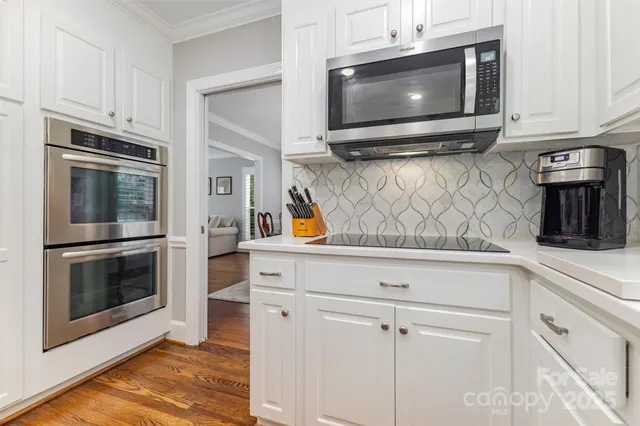 a kitchen with stainless steel appliances granite countertop a stove microwave and cabinets