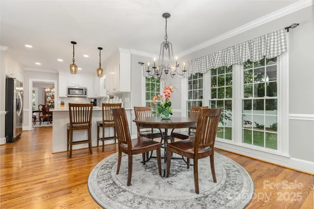 a view of a dining room with furniture window and wooden floor