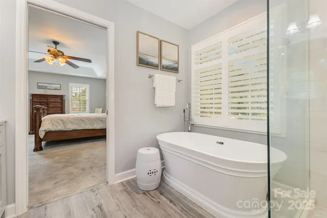 a bathroom with a tub and a shower