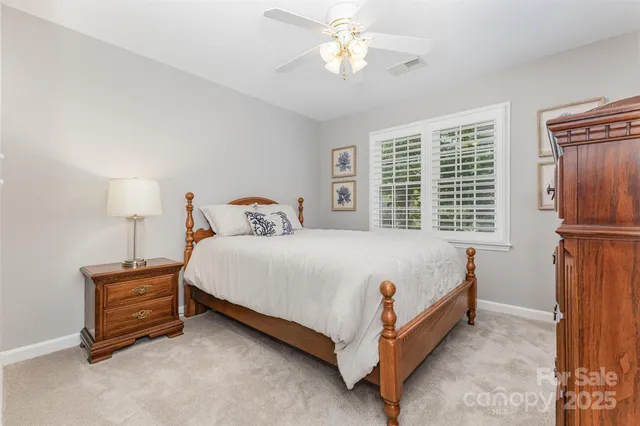 a bed sitting in a bedroom next to a window