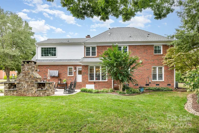 a front view of a house with a garden and yard