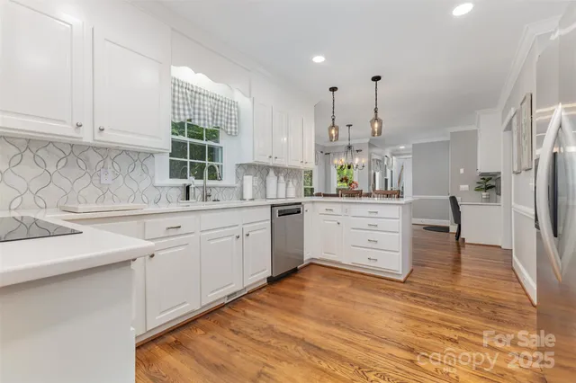 a kitchen with white cabinets and white appliances