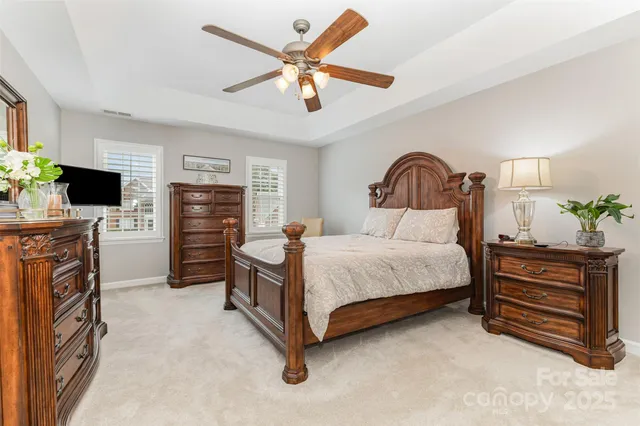 a bedroom with a bed dresser and flat screen tv