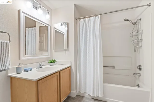 a bathroom with a sink a mirror and a shower