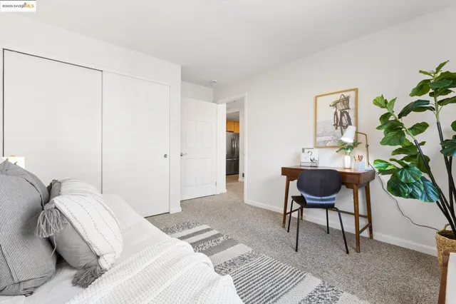 a bedroom with a bed and a chair