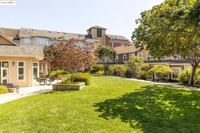 a front view of a house with a garden and trees
