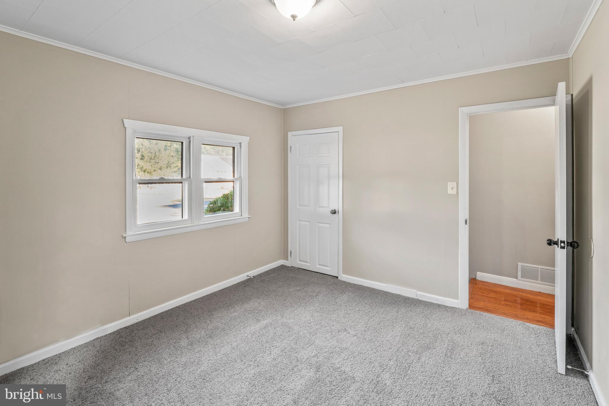 83 Rutgers Road Pennsville, NJ 08070 - Photo 14 of 23 a view of an empty room with a window