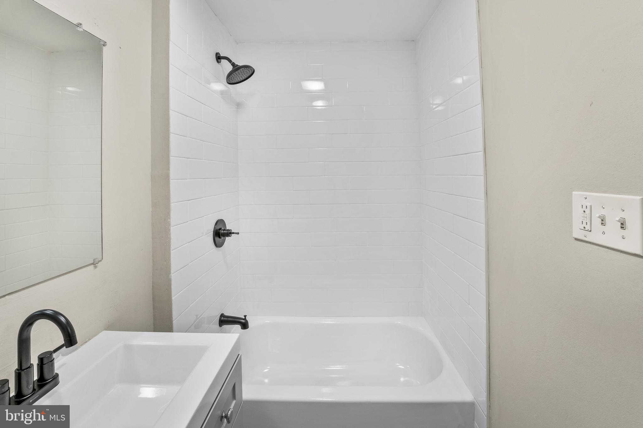 83 Rutgers Road Pennsville, NJ 08070 - Photo 18 of 23 a bathroom with a sink a mirror and a bathtub