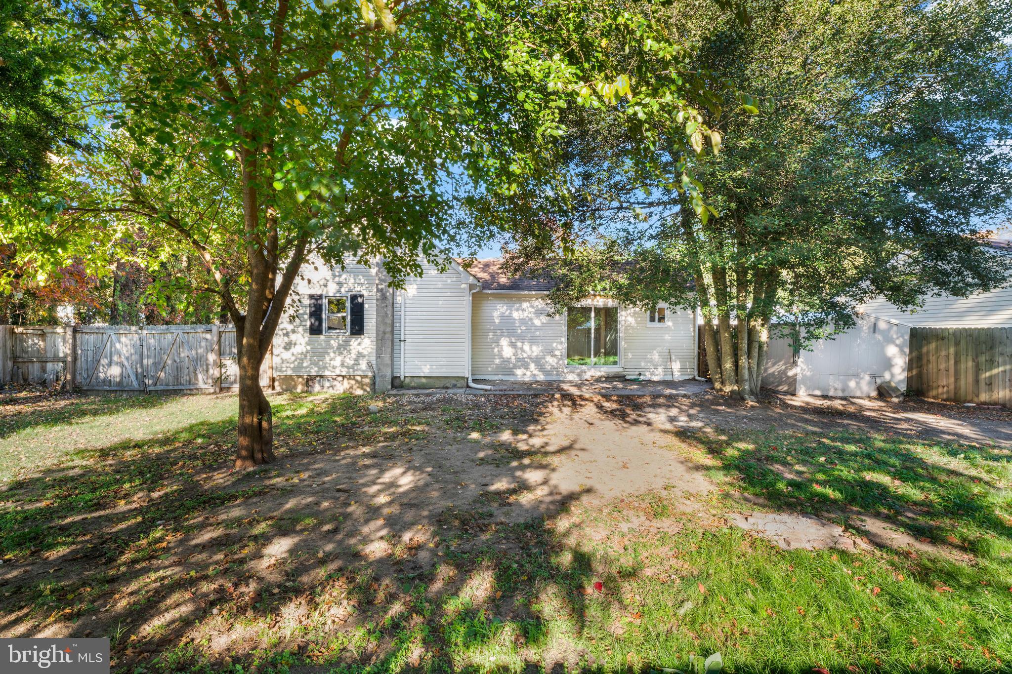 83 Rutgers Road Pennsville, NJ 08070 - Photo 21 of 23 a view of a yard with plants and large trees