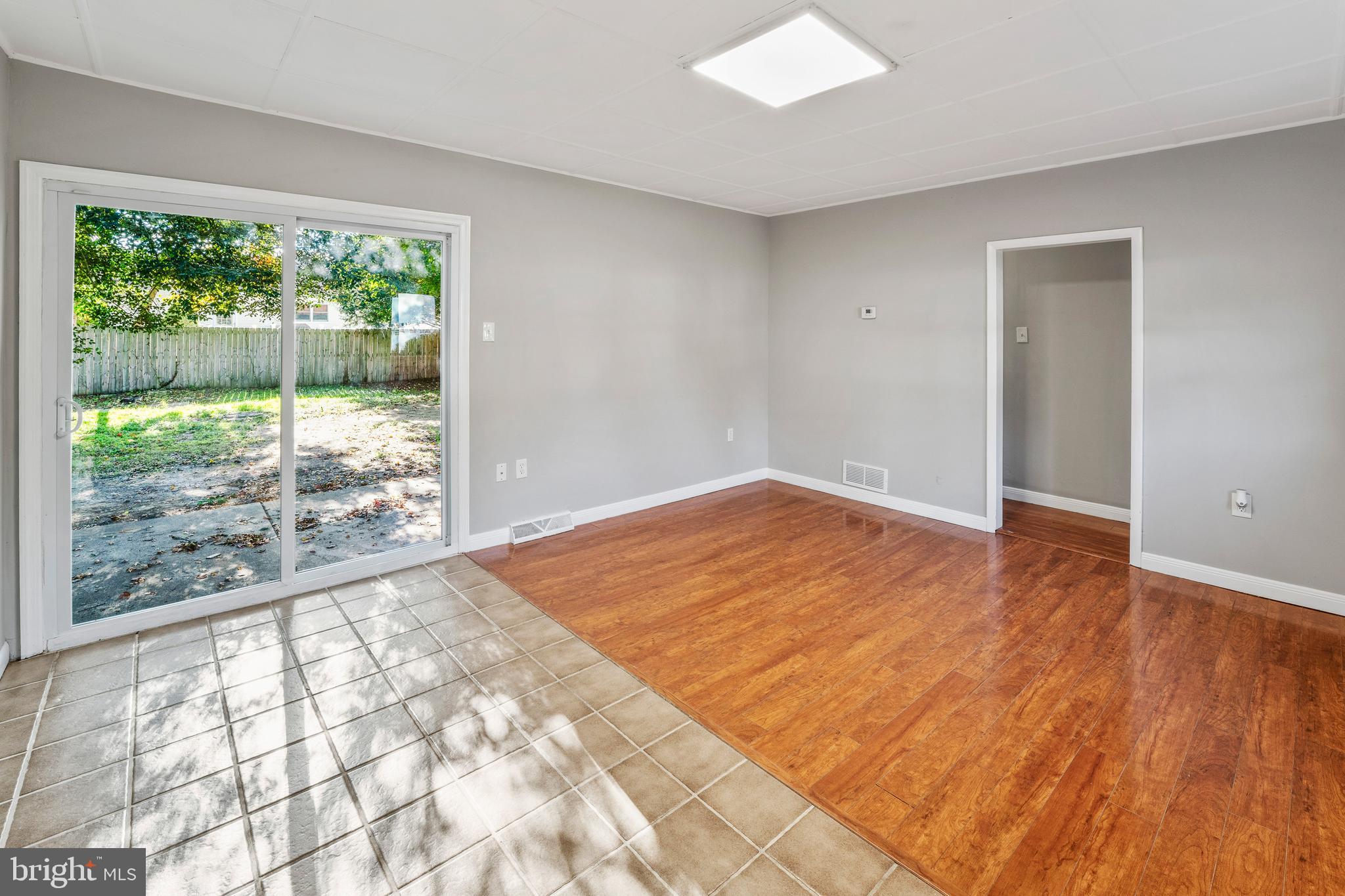 83 Rutgers Road Pennsville, NJ 08070 - Photo 5 of 23 a view of empty room with wooden floor and fan
