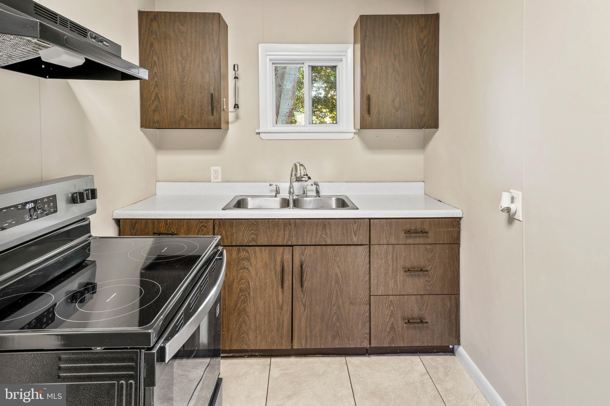 83 Rutgers Road Pennsville, NJ 08070 - Photo 10 of 23 a kitchen with a sink a stove and a microwave