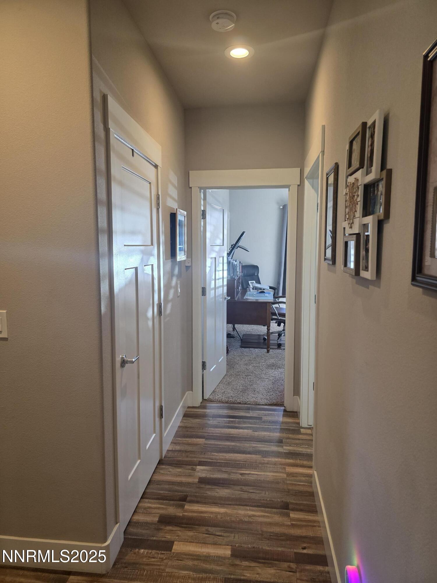 1145 Cheatgrass Drive, Unit BETWEEN DAFFODIL AND ALMOND CREEK Dayton, NV 89403 - Photo 12 of 40 a view of a hallway with wooden floor and closet