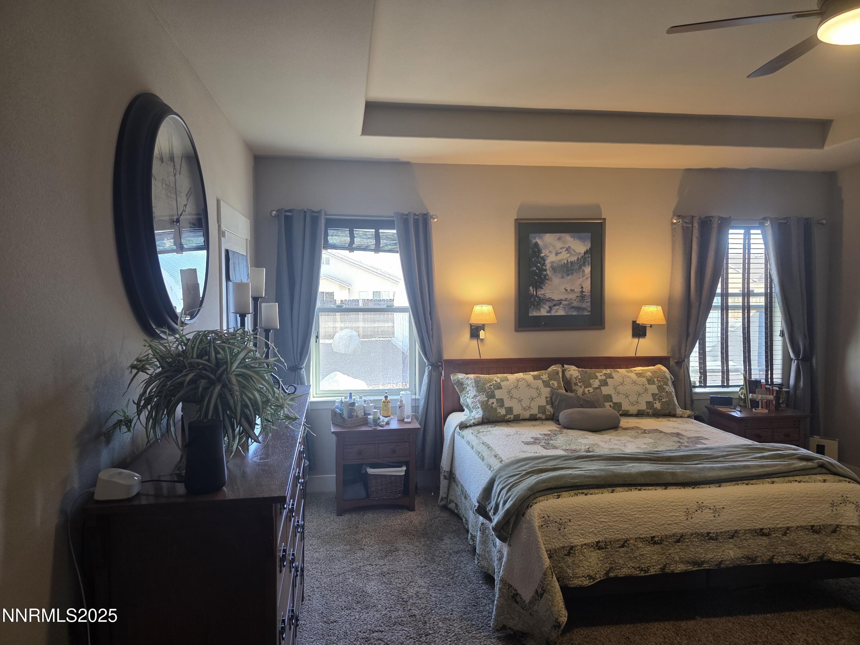 1145 Cheatgrass Drive, Unit BETWEEN DAFFODIL AND ALMOND CREEK Dayton, NV 89403 - Photo 14 of 40 a bedroom with a bed and a large mirror next to a window