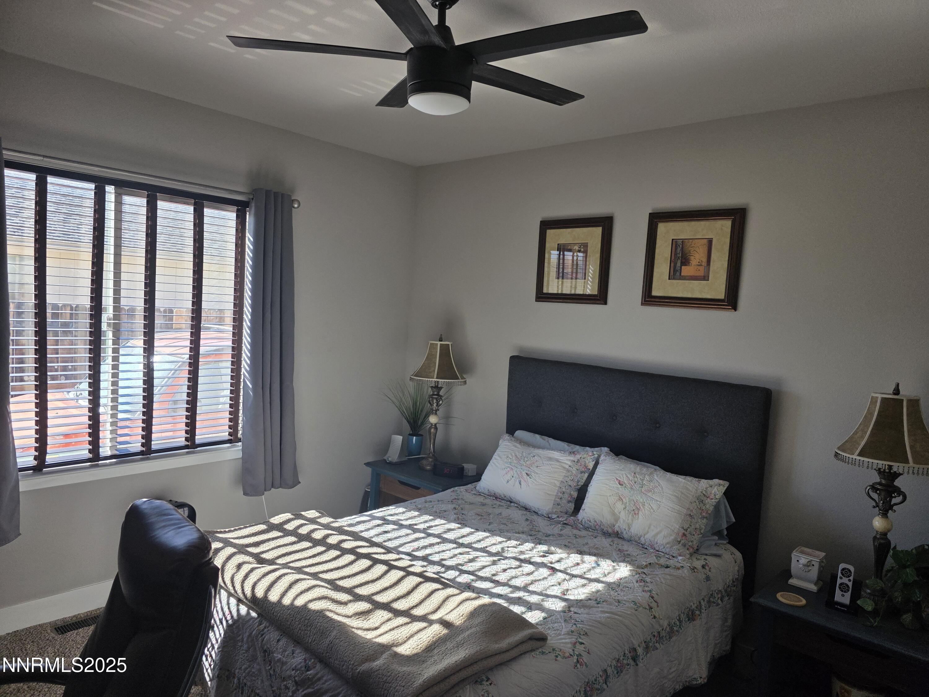 1145 Cheatgrass Drive, Unit BETWEEN DAFFODIL AND ALMOND CREEK Dayton, NV 89403 - Photo 18 of 40 a bedroom with a bed and a window